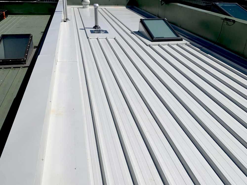 Roof under repair with new coating applied