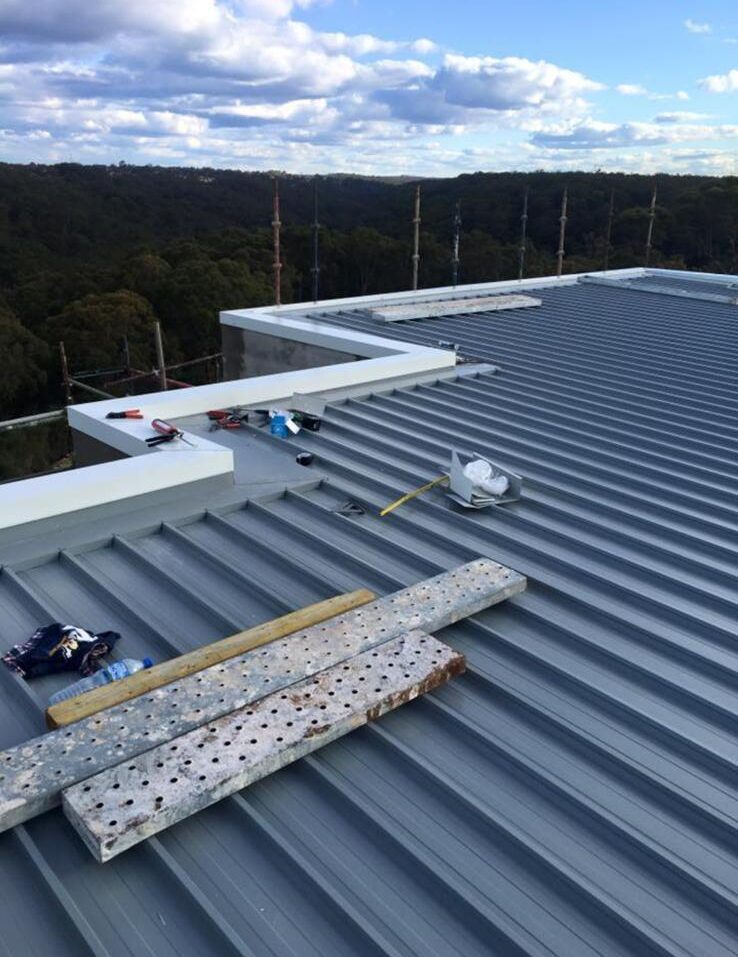 Roofer repairing a roof leak source